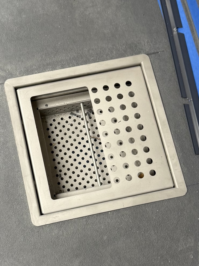 Commercial floor drain set into a seamless kitchen floor